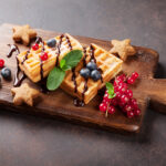 American Waffles and berries on wooden board