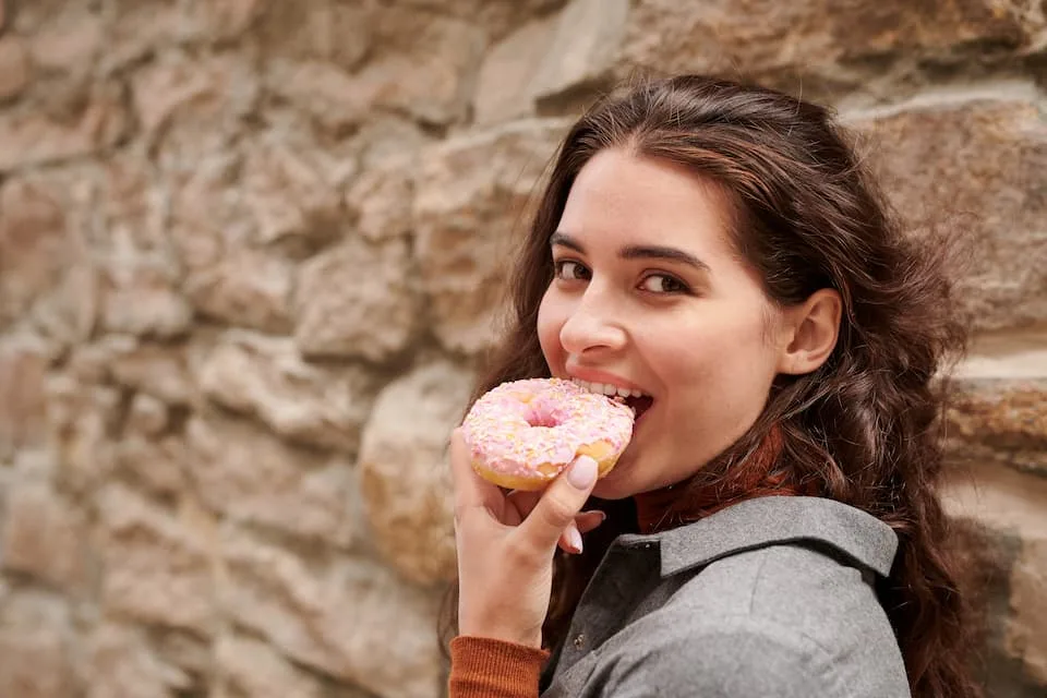 girl eating doughnut, one of the popular street food - Chef's Deal