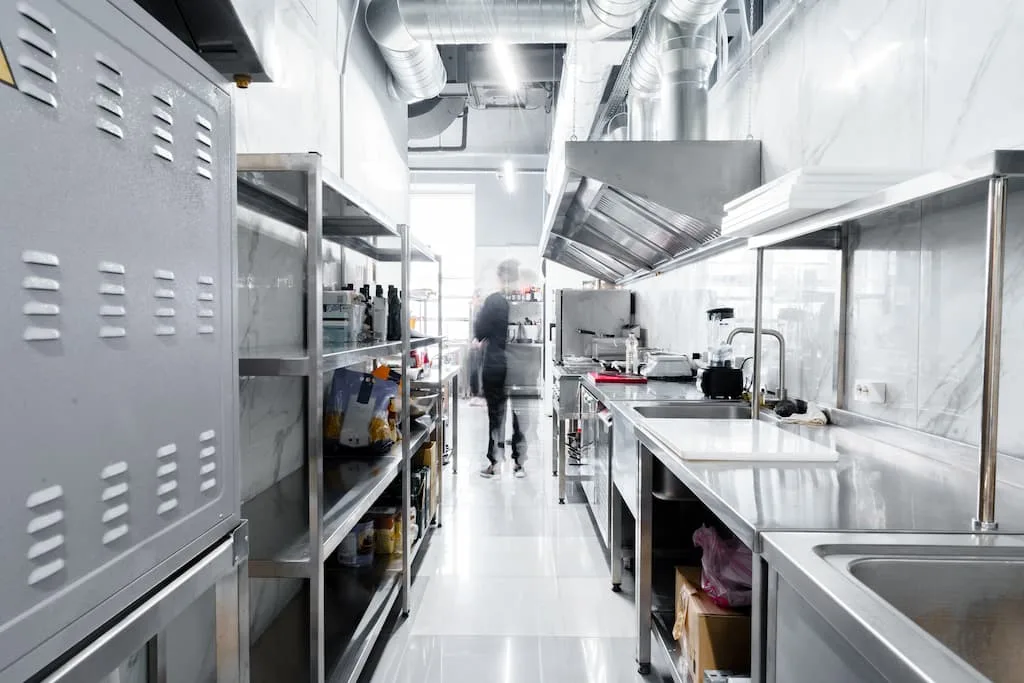 Ease of Cleaning and Maintenance is important for commercial kitchen - A clean commercial kitchen flooring with equipment.