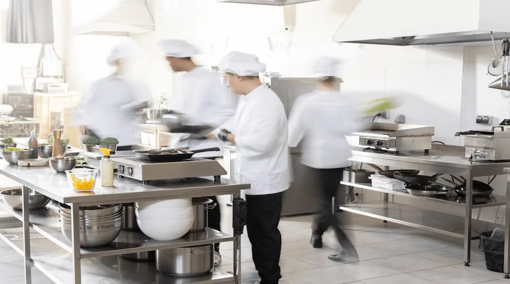 Chefs are working in a well space optimized kitchen.