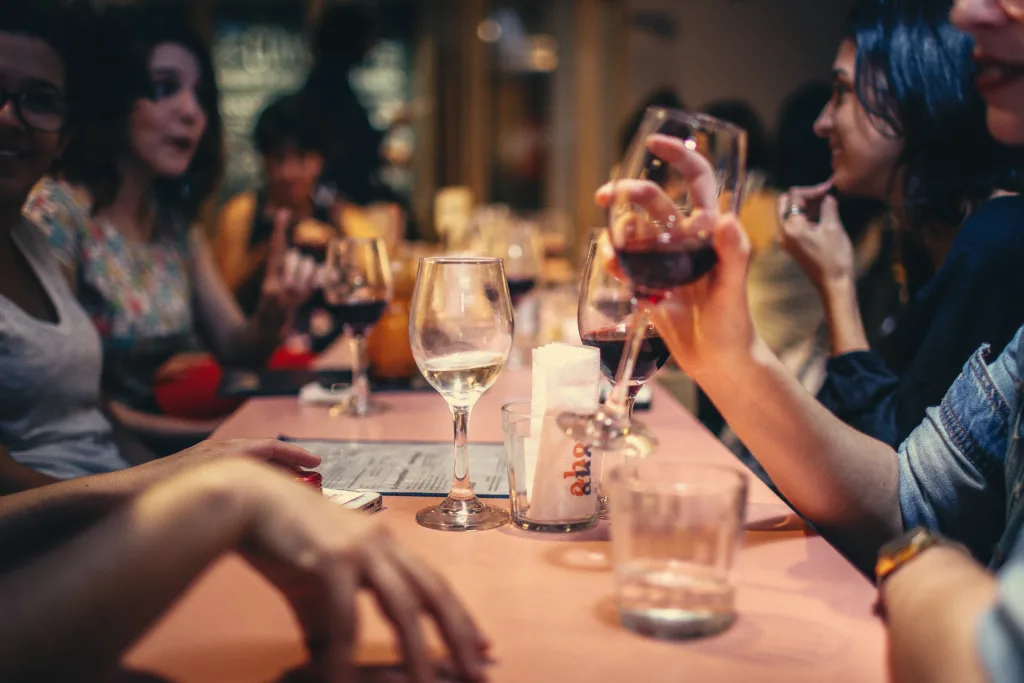 Restaurant Dining is Making a Comeback! -  A group of people dining together with wine glasses. 