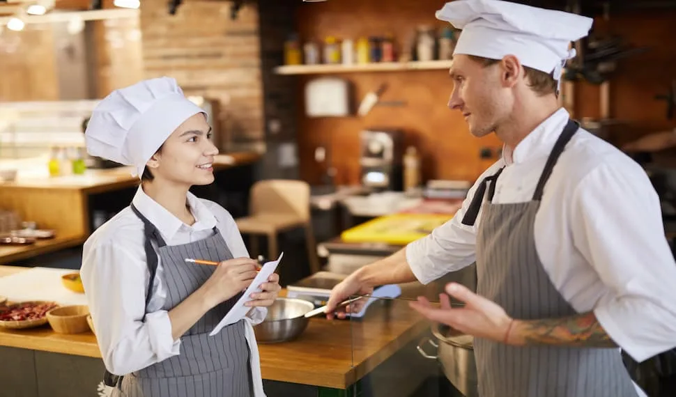 A young cook in training in restaurant kitchen. - Restaurant Kitchen Safety Tips
